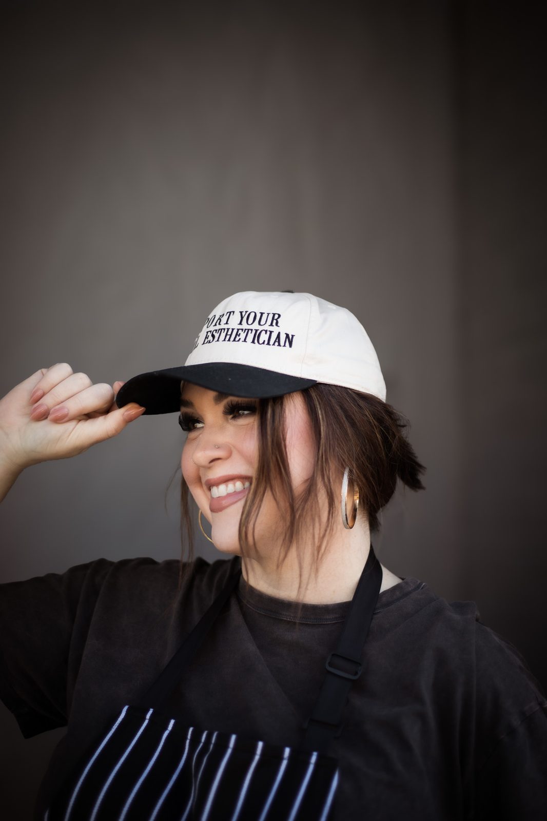 Smiling esthetician in a cap during a business branding session